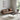 Modern living room with a brown sofa, coffee table, and armchair.